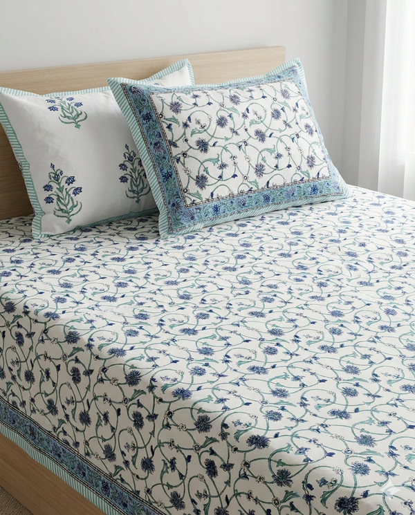 Folded Fursat Blue Floral Jaal 500 TC Arka Luxe Cotton bedsheet highlighting the ivory base, intricate blue floral pattern, and muted green border.