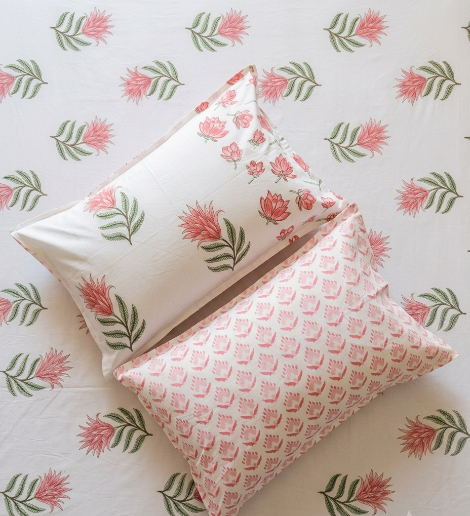 Matching pillow covers with pink floral motifs and coordinating border from the GUL Arka Luxe Cotton bedsheet set.